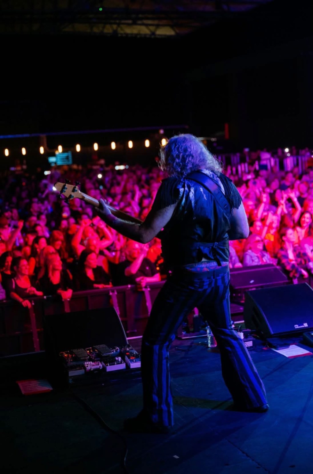 Gaz Williams playing bass in front of a festival audience